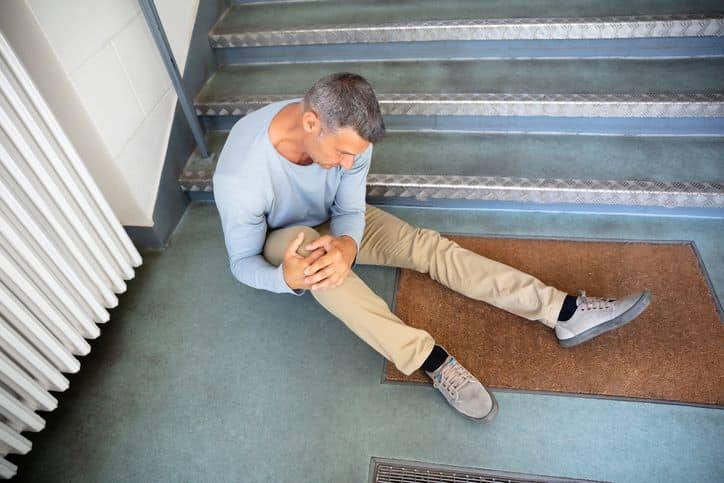 man on the floor after falling down stairs