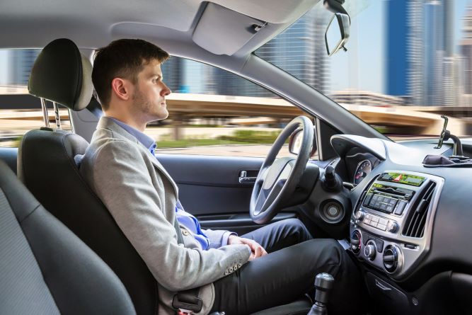 man in self driving car