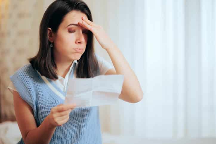 Woman stressed looking at paper