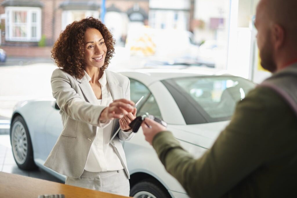 Woman-receiving-keys-for-leased-car-1536x1024