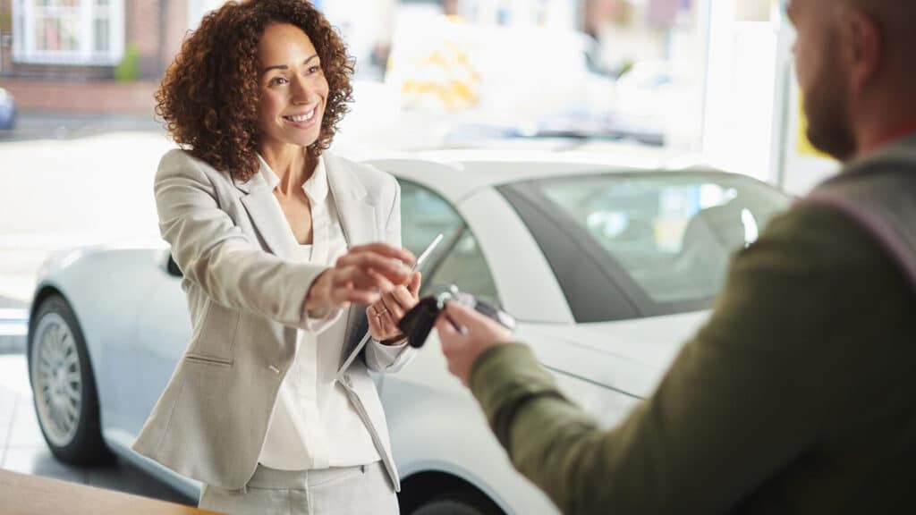 A woman receiving the keys for her new vehicle.