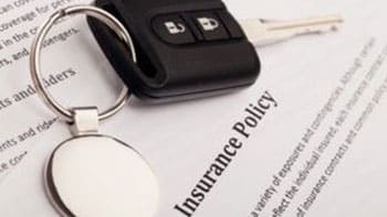car keys on a car insurance document