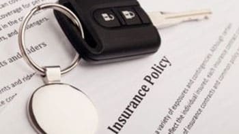 Car keys on a car insurance document