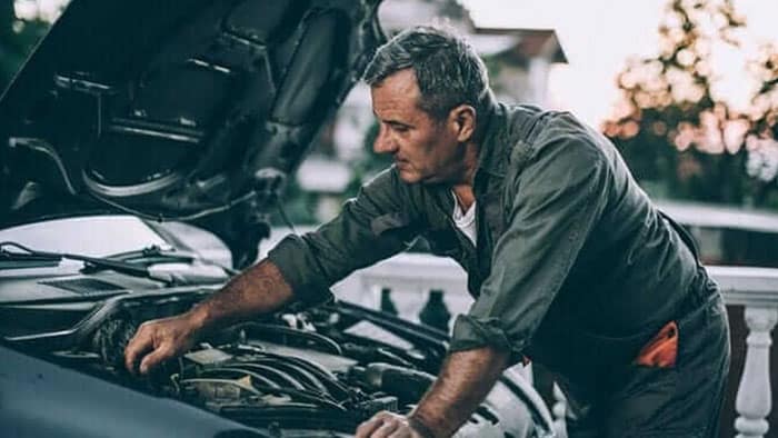 mechanic working on a car engine