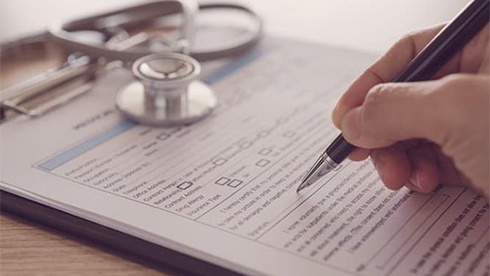 a person filling out medical records for a personal injury