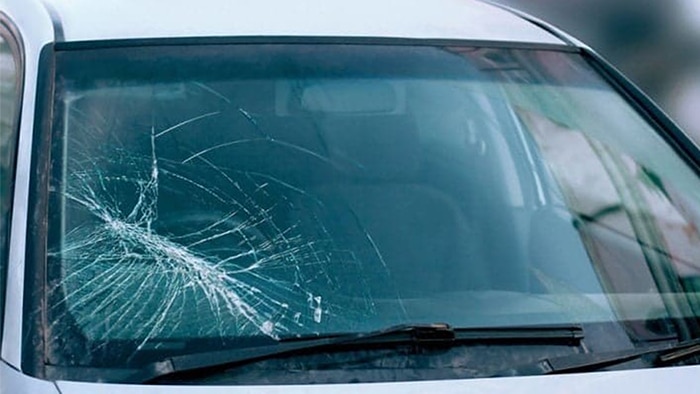 the windshield of the car cracked from the gravel