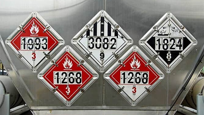 Hazmat warning signs on back of truck