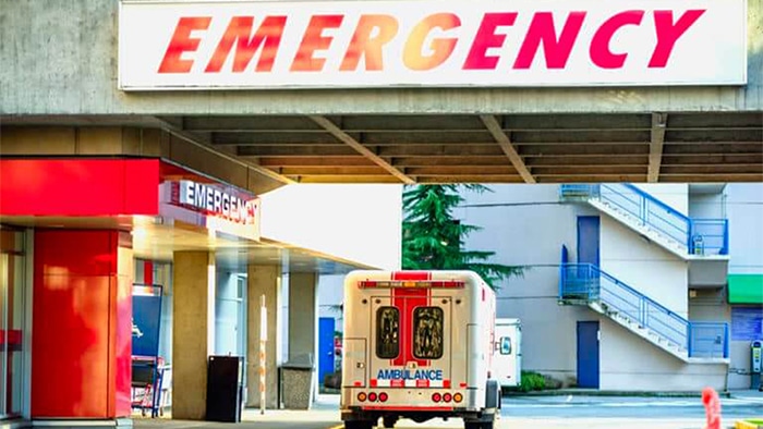 outside of an emergency room with an ambulance parked in front