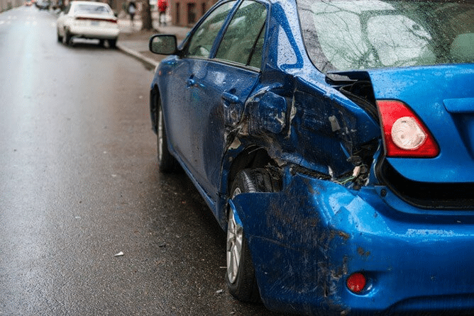 blue car with a crushed backend after a car accident