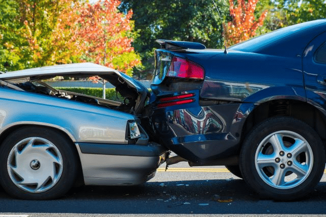 auto accident involving a gray car rear-ending a blue car