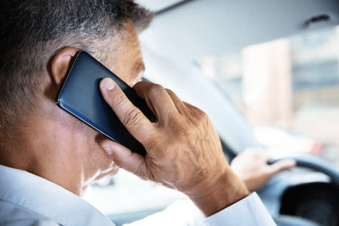 man using cell phone while driving