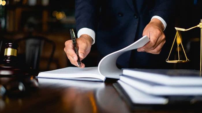 personal injury lawyer signing documents