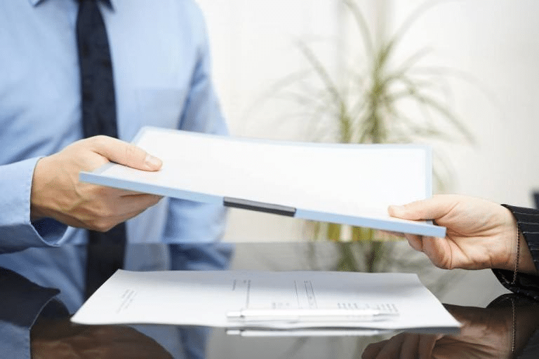 wrongful death lawyer handing over paper work