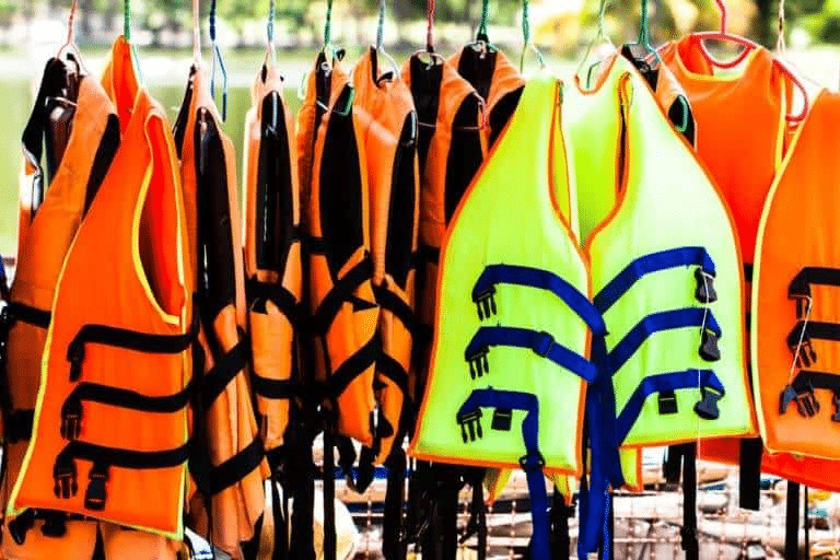 A row of safety vests hanging next to each other.