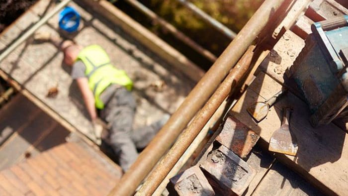 An aerial view of an injured worker who's fallen off a roof.