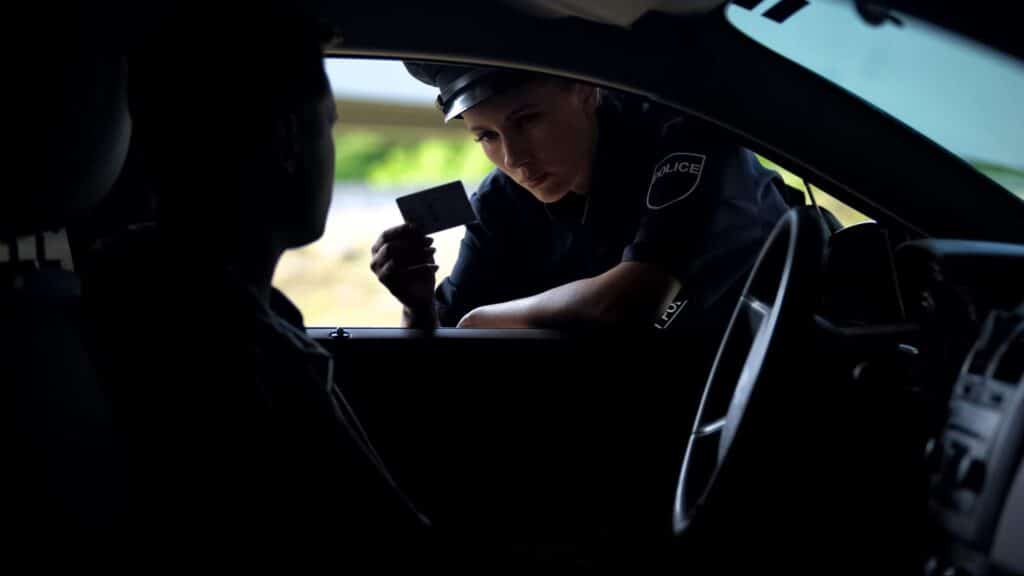 police woman checking drivers id