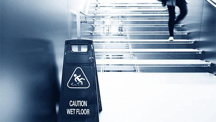 Wet floor sign by stairs