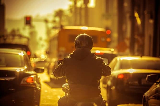 motorcycle-rider-splitting-lanes-in-traffic