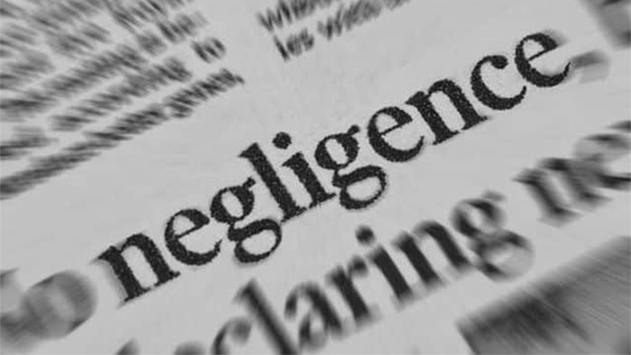 A close-up view of the word "negligence" in a paper.