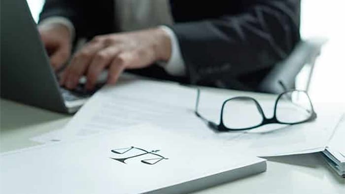 personal injury lawyer typing on a computer