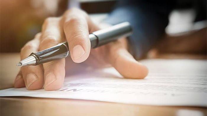 Personal injury lawyer signing documents