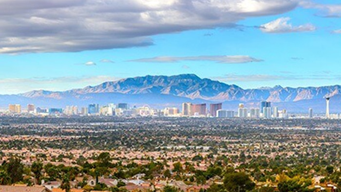 City skyline of Las Vegas with mountains appearing in the background.