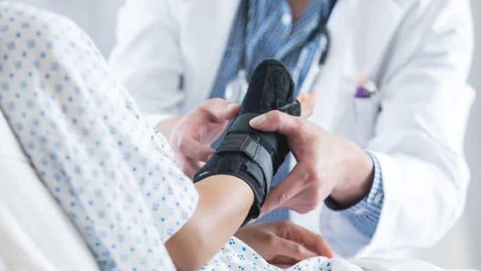 Doctor checking patients arm brace