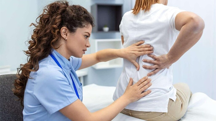 doctor checking patients back pain