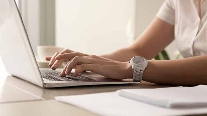 person typing on a laptop