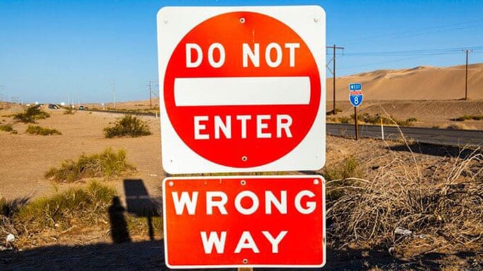 A "Do Not Enter - Wrong Way" road sign.
