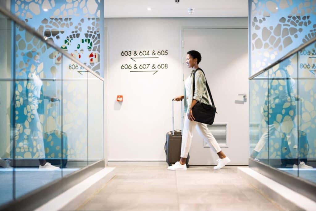 Lady with luggage walking through hotel