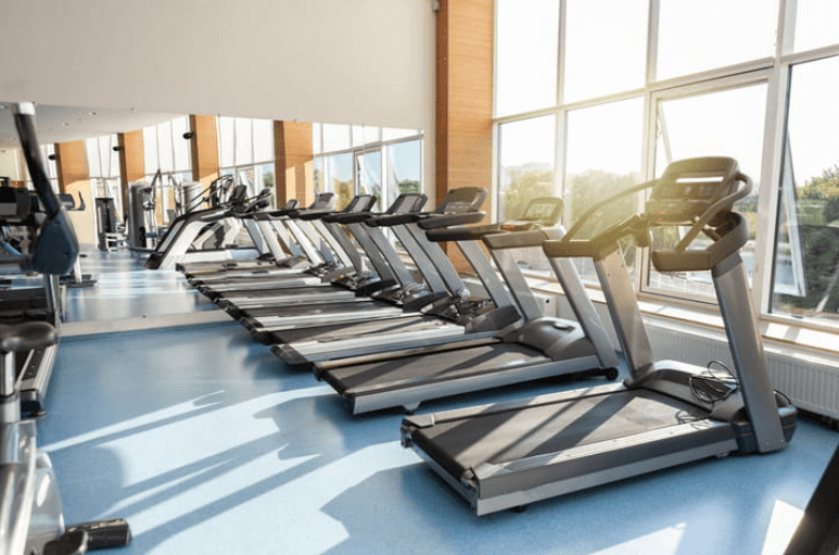 a row of treadmills at a gym