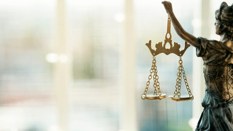 How To File An Insurance Claim 1 An out of frame statue holding the scales of justice
