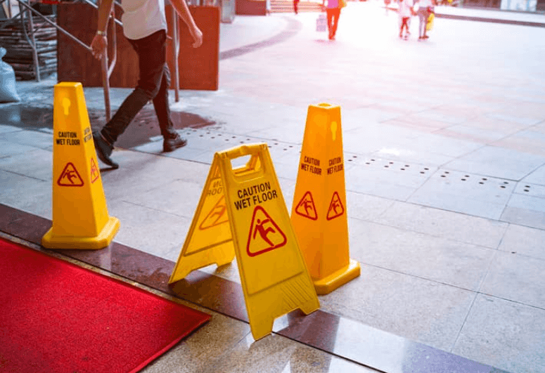three yellow caution: wet floor signs