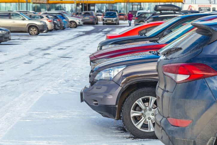 Cars parked in a busy parking lot.