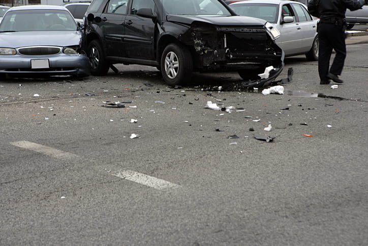 a multi-car accident. 3 vehicles are smashed up in from colliding.