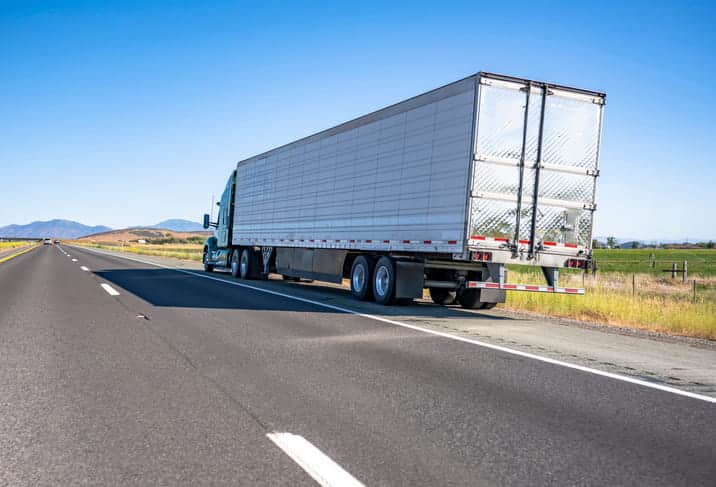 A broken down semi on the side of the road after a commercial truck accident.