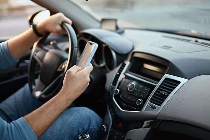 man-is-texting-while-driving