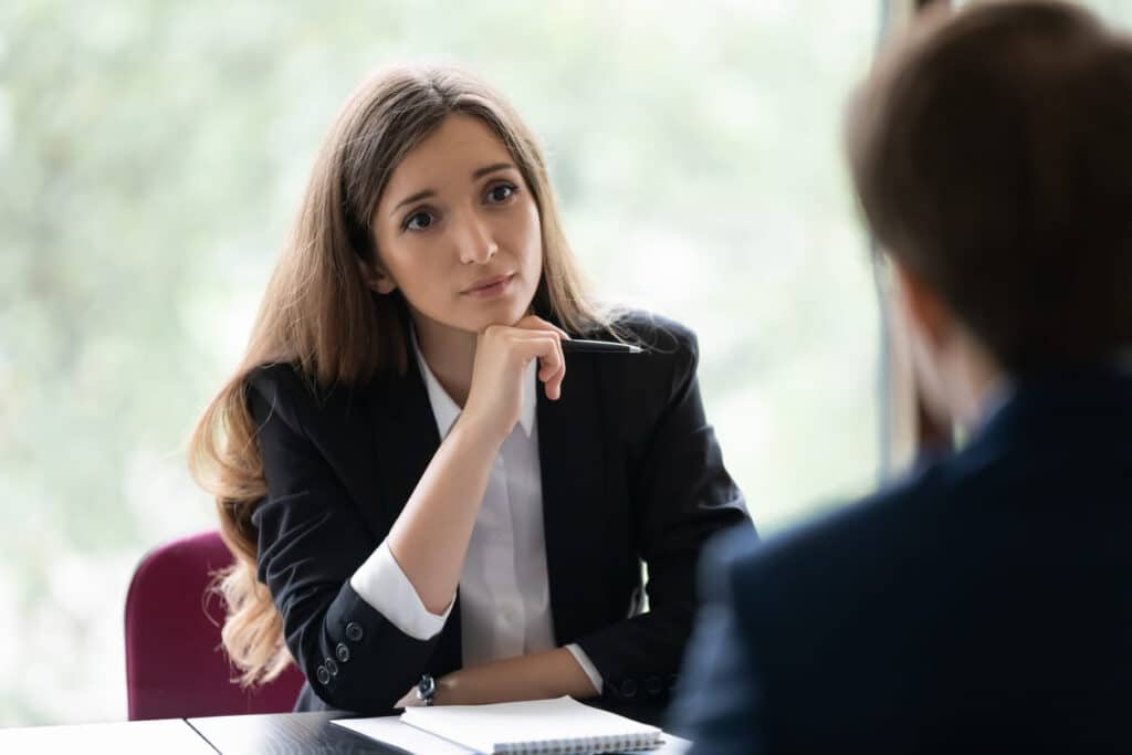 A female personal injury lawyer listening to her client about their auto accident case.