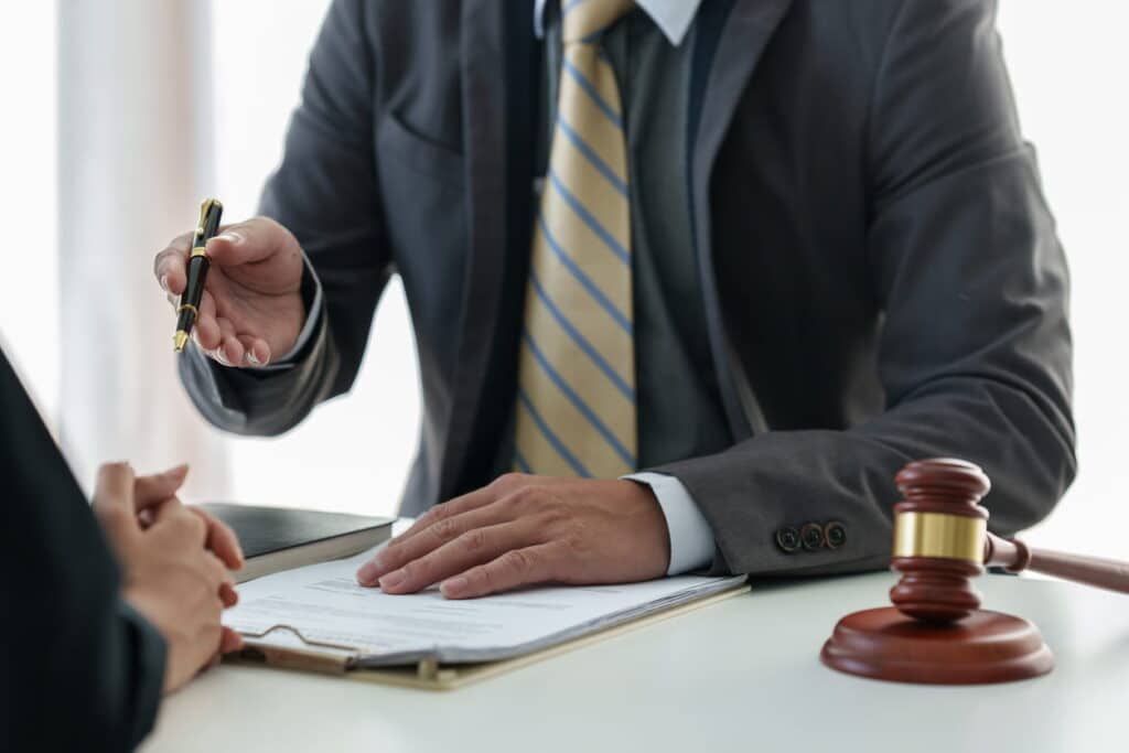 Henderson Dog Bite Attorney 2 A dog bite attorney speaking with their client. In front of them is paperwork and a gavel.