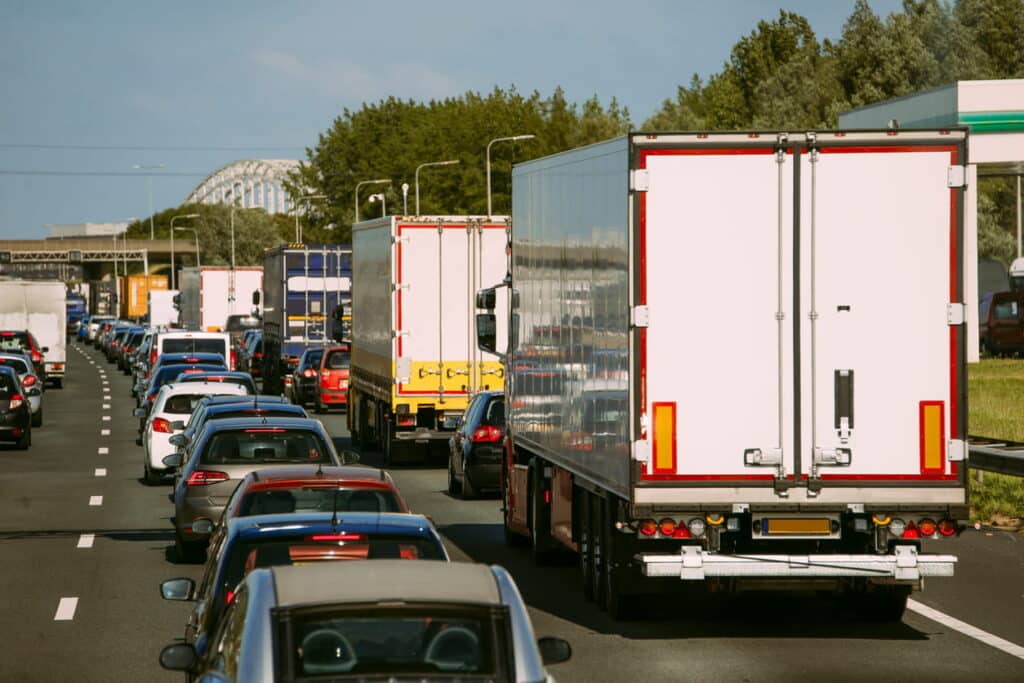 A traffic jam full of cars and semi-trucks.