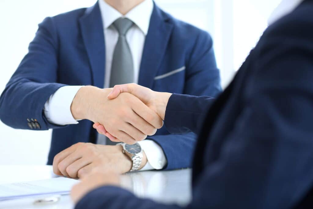 A truck accident attorney shaking their client's hand. 