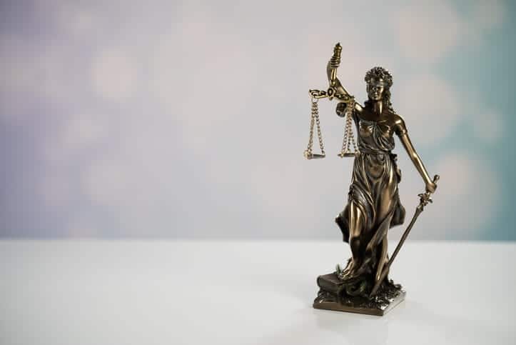 A Lady Justice statue on a personal injury attorney's desk. 