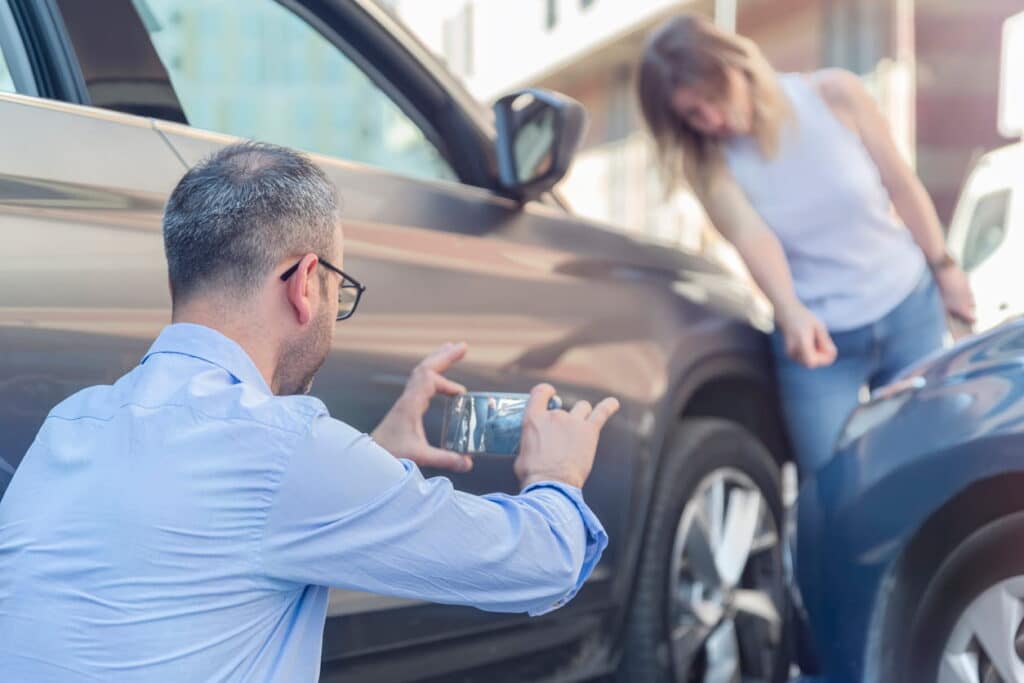 Las Vegas Woman pointing to car accident damage