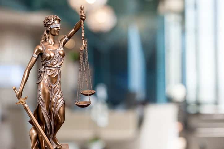 A Lady Justice statue on a workers' comp lawyer's desk. 