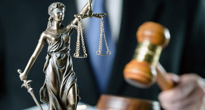 Summerlin Slip-And-Fall Attorneys 1 A lady justice statue with a slip-and-fall accident lawyer using a gavel in the background.