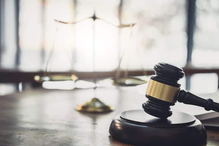 A gavel and the scales of justice on an attorney's desk. 