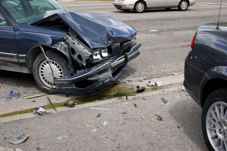 A severely damaged front end of a vehicle after a car accident. 