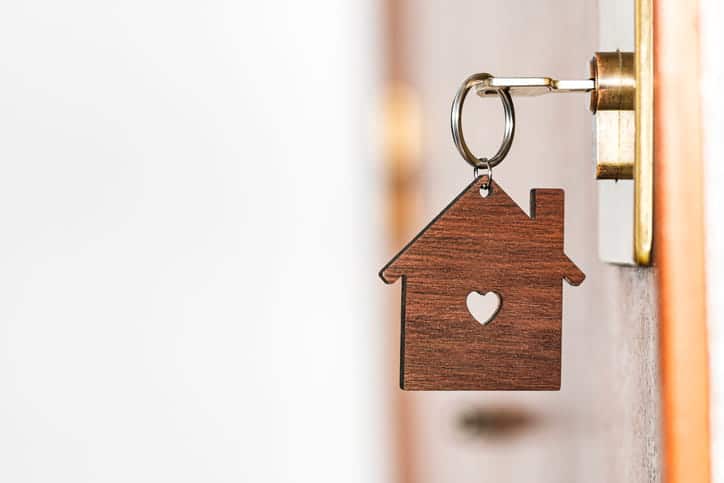 A house keychain hanging from a bed-and-breakfast door. 