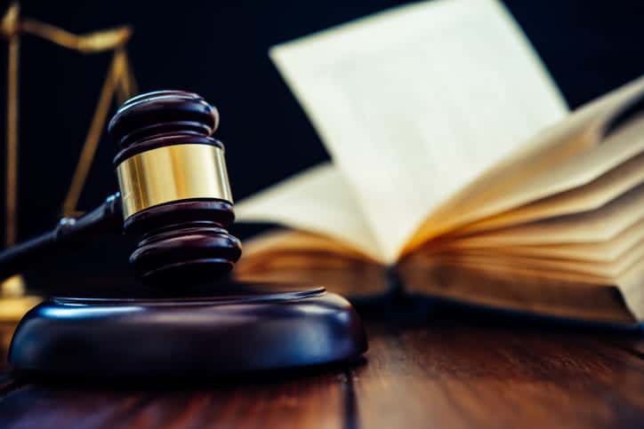 What Is Pip Coverage And How Does It Work? 1 A gavel in front of an open book on a car accident injury attorney's desk.